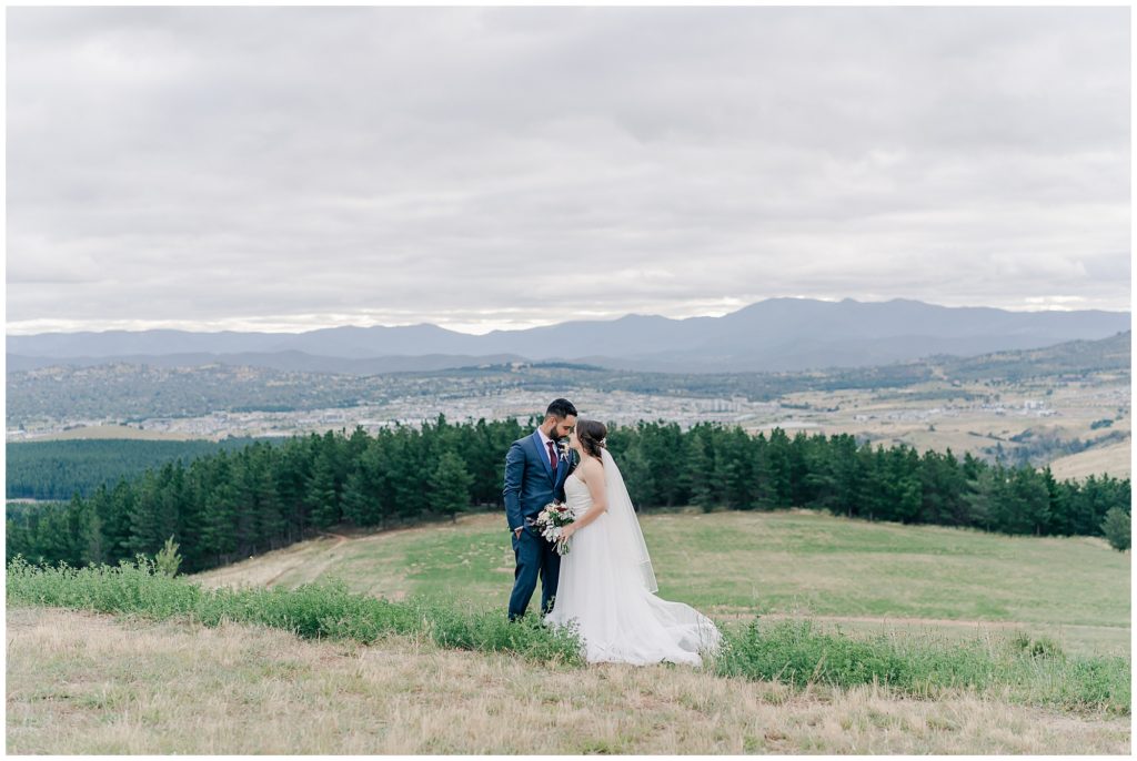 Wedding couple at the top of a mountain at the arboretum| Canberra wedding photographer