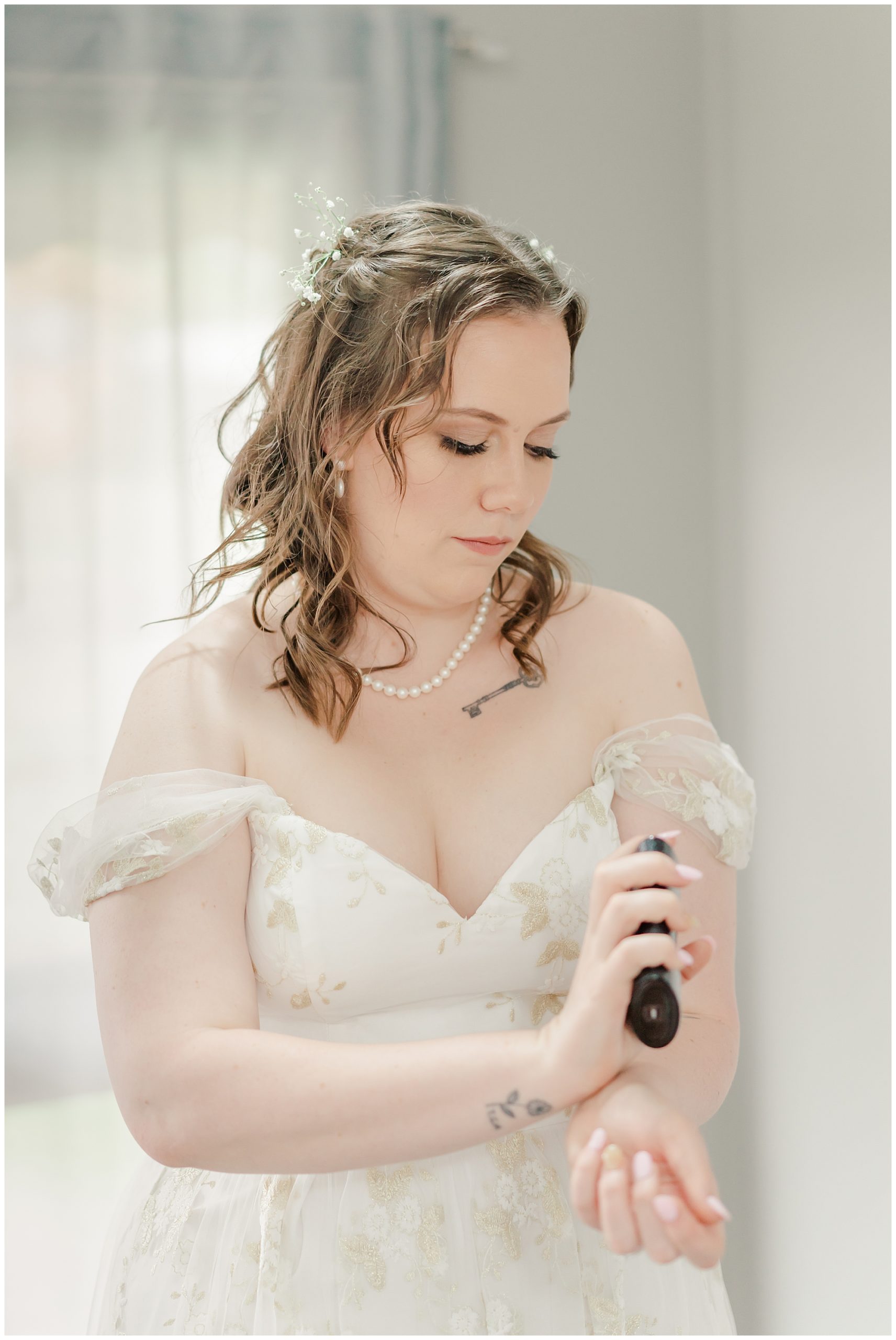 Bride putting on her perfume before  the wedding 