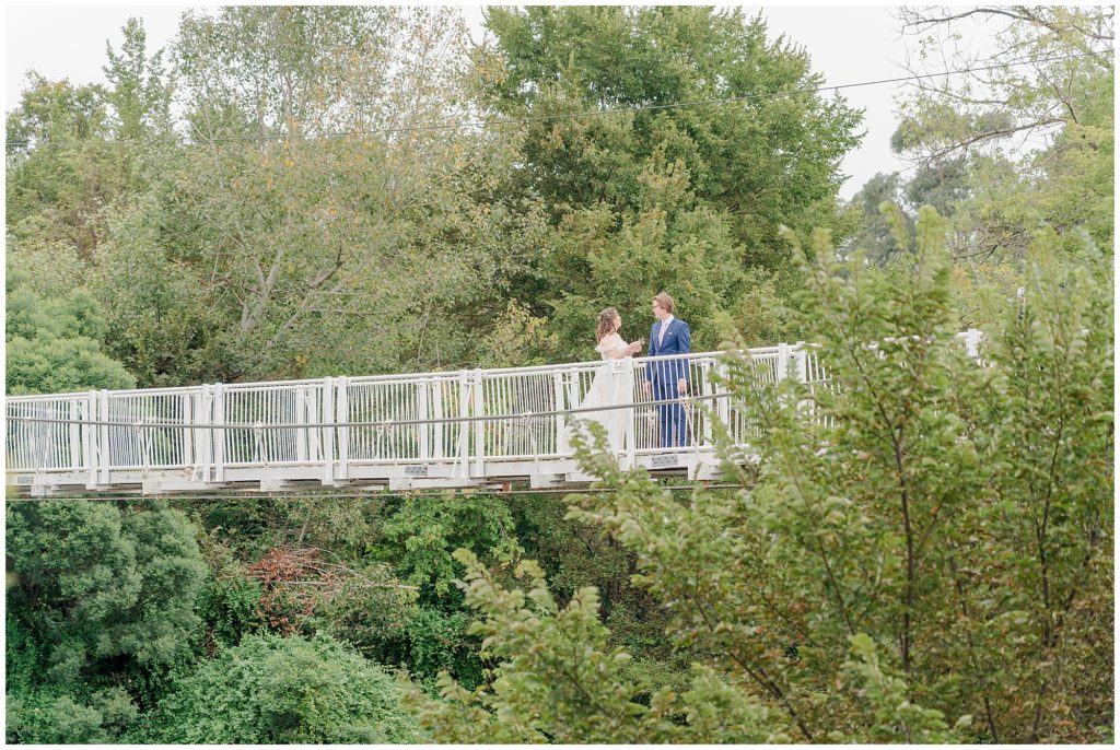 Bride and groom standing on a hanging  bridge  in Canberra
