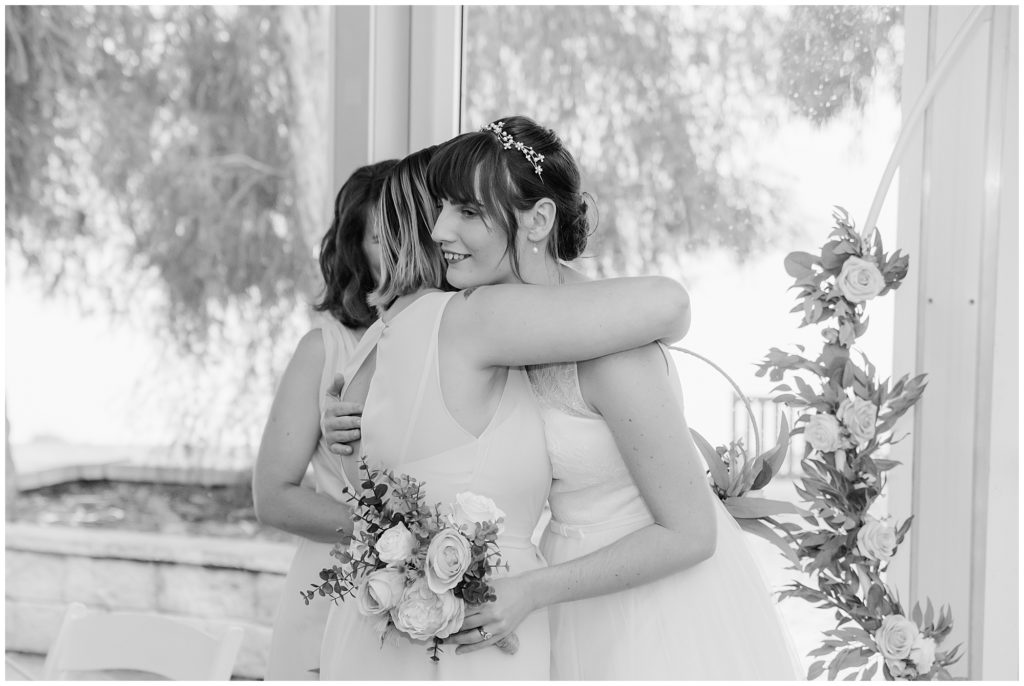 Bride hugging her sister after the wedding ceremony