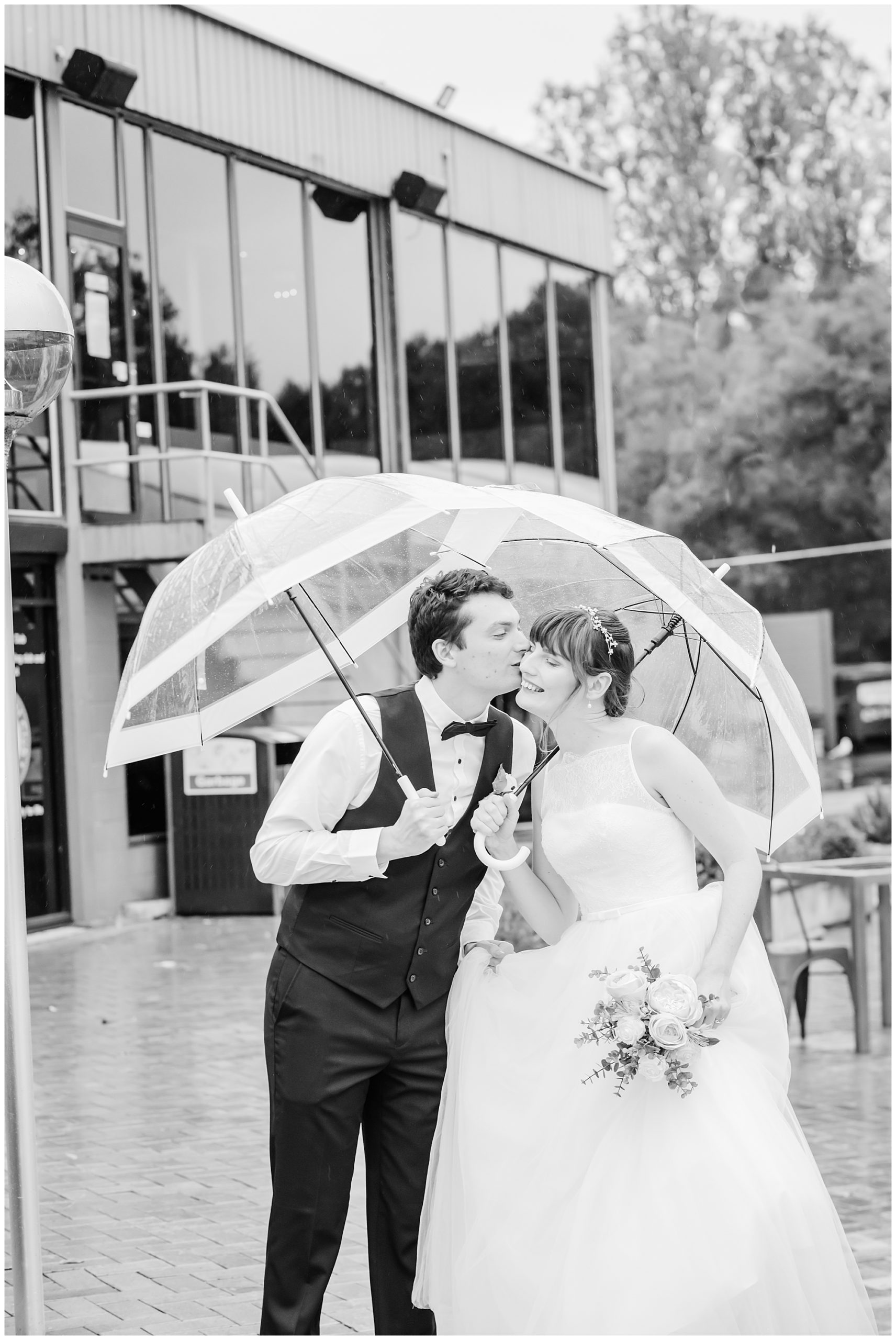 Canberra Wedding photographers| Bride and groom with umbrellas  on a rainy day at the Yacht club