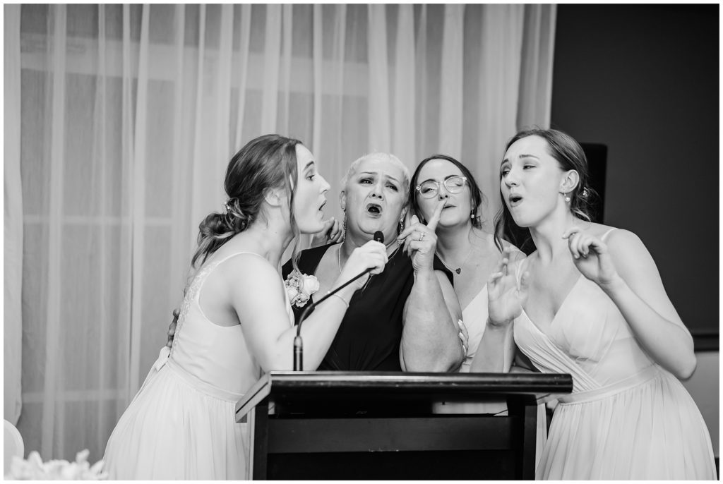 Bridesmaids singing  at wedding