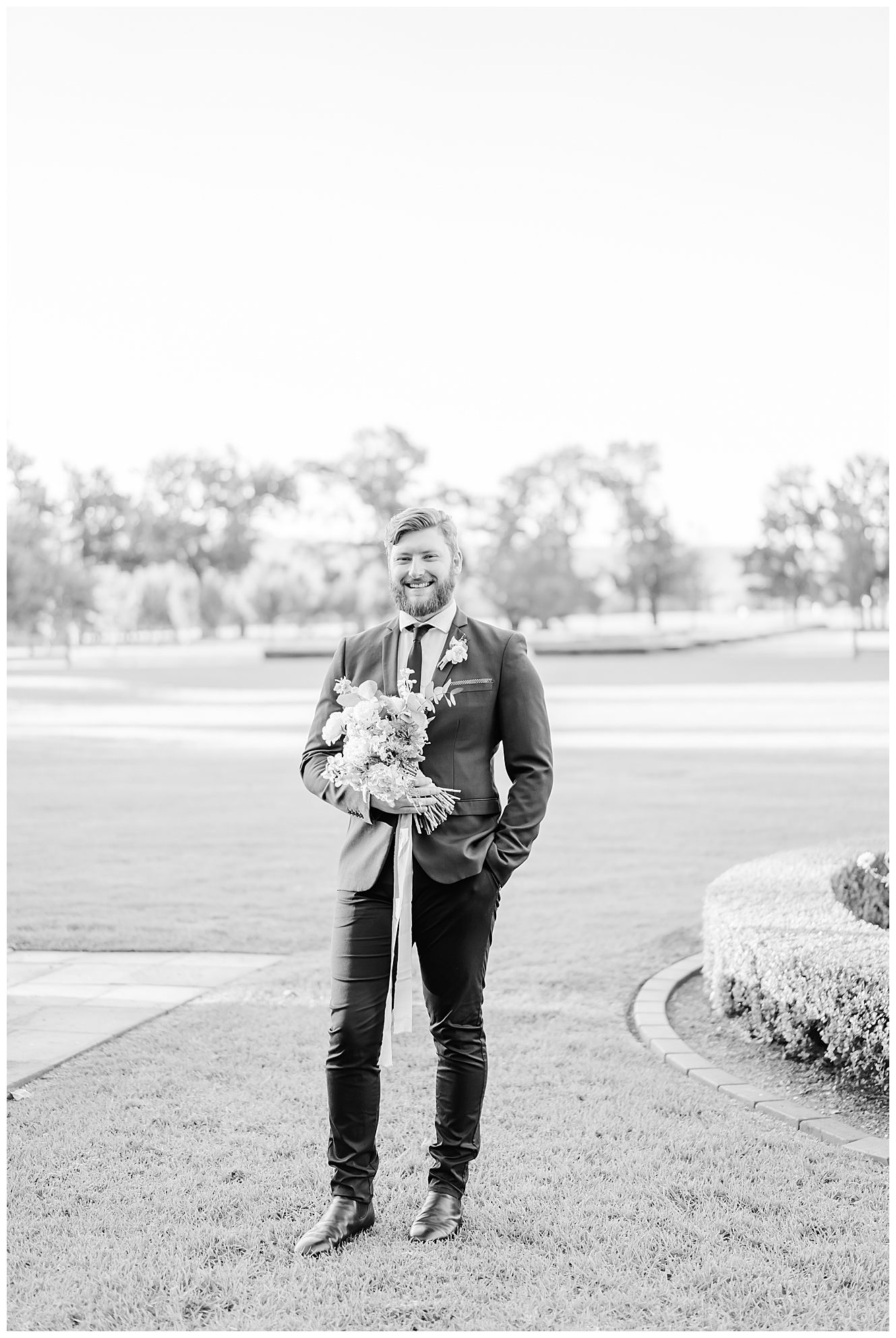 Groom holding the brides bouquet 